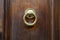 Brass ring knocker on old wooden door in Florence