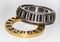 Brass roller cage of a thrust roller bearing and stainless roller cage of a tapered roller bearing