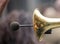 Brass trumpet, front side with microphone for loud sound. Close up view with details, blurred background.