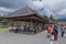 Bratan Lake, Bali - November 25th, 2017: Visitors resting under a unique architectural design hut with local photographer