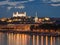 Bratislava castle at night with light reflection on the dunaj ri