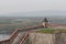 Bratislava, Slovakia - April, 2011: hazy hill, forest, Danube river, old cozy tower with stairway and garden view from hill of Bra