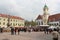 Bratislava, Slovakia - April, 2011: Maximilian`s fountain, people on easter fair and yellow tower of Old Town Hall on Hlavne squa