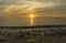 Brautiful golden sunrise scene with Hatta island on the horizon far away seen from campsite Besar island