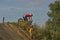 A brave biker jumps very high on a motorcycle and performs a stunt.