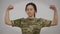 Brave confident military woman gesturing strength gesture looking at camera. Portrait of strong courageous Caucasian