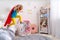 Brave cute little girl jumps out of bed, imagining flight