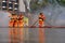 Brave firefighter using extinguisher and water from hose for fire fighting, Firefighter spraying high pressure water to fire,