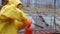 Brave fireman in yellow uniform extinguishes flame with extinguisher in barbeque grill. Fireman using extinguisher for