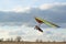 Brave girl learn to fly on the colorful hang glider wing