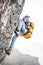 Brave lifestyle climber with professional backpack climb to the rock