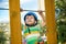 Brave little boy having fun at adventure park and smiling to camera wearing helmet.