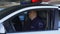 Brave police officers sitting into patrol car ready to city patrolling, order