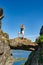 Brave traveler woman standing on hanging stone between rocks. Djevelporten in Norway Lofoten islands