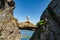 Brave traveler woman standing on hanging stone between rocks. Djevelporten in Norway Lofoten islands