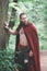 Brave Warrior Viking man in red cloak outdoor
