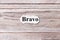 BRAVO of the word on paper. concept. Words of BRAVO on a wooden background