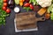 Brawn cutting board and fresh farmers garden vegetables on stone background. Harvest time. Top view