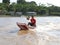 Brazil: Boy in a Motor Boat on an Amazon Tributary