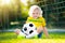 Brazil football fan kids. Children play soccer.