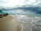 Brazil, Porto de Galinhas beach. Weat sand, waves, cloudy storm sky in the background.