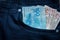 Brazilian bank notes in the jeans pocket