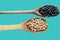 Brazilian beans in a wooden spoons on blue background