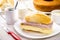 Brazilian breakfast, french salt bread with mozzarella cheese and ham, served with hot coffee and cornmeal cake