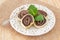 Brazilian chocolate dessert Bolo de rolo (swiss roll, roll cake) on white plate with mint