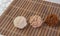 Brazilian cocada coconut candy placed on a wooden mat on a table with white towel, selective focus