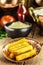 Brazilian cuisine, called polenta, traditional brazilian fries, with cornmeal and sauce in the background, rustic setting
