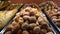 Brazilian donuts sprinkled with sugar being displayed at a Brazilian bakery showcase