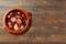 Brazilian feijoada, traditional food from Brazil cuisine, on ceramic casserole bowl, over rustic wooden table. Copy space