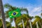 Brazilian flag with palm trees and blue sky background Brazil