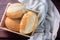 Brazilian French bread, in basket, on rustic wooden table for breakfast