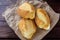 Brazilian French bread, on rustic paper, on rustic wooden table for breakfast