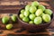 Brazilian fresh fruit Spondias tuberosa (Brazil plum, umbu, imbu) in bowl on wooden table