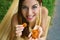 Brazilian girl eating dried apricots outdoors. Healthy food concept