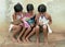 Brazilian girls reading books on road side