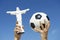 Brazilian Hands Holding Soccer Ball Football and Christ Corcovado Statue