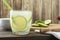 Brazilian lemon caipirinha in a glass with ice with fruit slices over wooden board