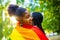 brazilian lesbian couple in white dress spending time together celebrating engagement in summer park outdoor