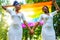 brazilian lesbian couple in white dress spending time together celebrating engagement in summer park outdoor