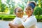 brazilian lesbian couple in white dress spending time together celebrating engagement in summer park outdoor