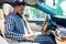 brazilian man fastening seat belt in car and ready to move