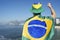 Brazilian Man Pumping Fist with Flag Rio Skyline