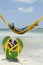 Brazilian Man Relaxing in Beach Hammock Over Sea