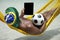 Brazilian Man Relaxing with Tablet and Football Beach Hammock