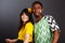 Brazilian and Nigeria fan couple in soccer uniform celebrate on gray background