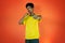 Brazilian Player- Black Man Celebrating With Yellow T Shirt Isolated on Orange background